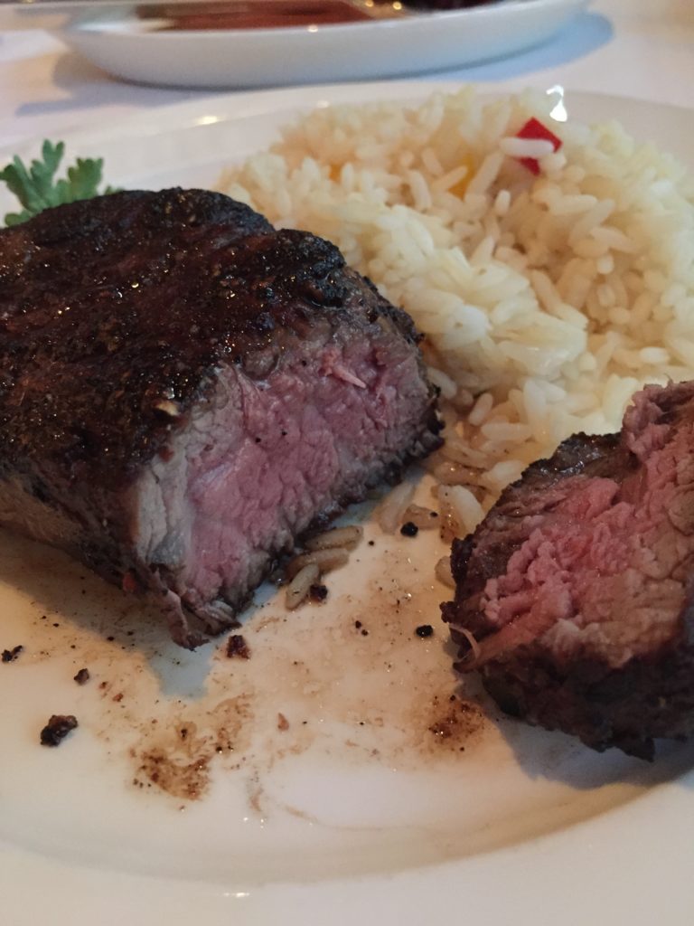 Filet mignon steak cooked medium with rice pilaf.